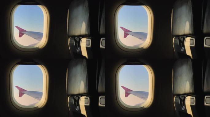 透过飞机窗户看飞机机翼在晚上