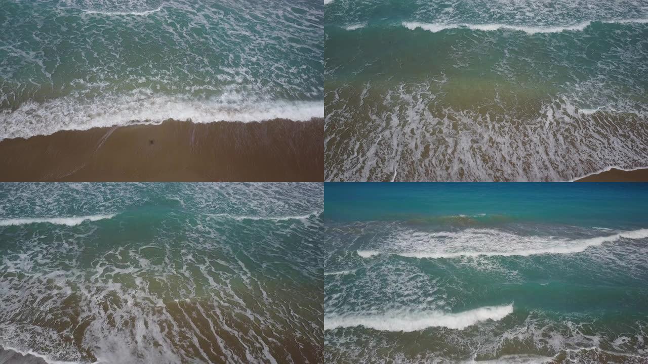 蓝绿色海浪席卷佛罗里达州海滨的棕榈滩