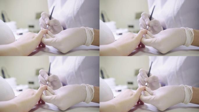 专业美甲大师在美甲过程中使用指甲小刷子涂抹指甲油的特写视频。新型冠状病毒肺炎锁定4k概念镜头中的小企