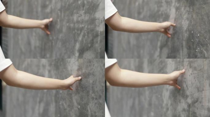 特写双手年轻女孩触摸柔和的墙壁背景一条小街道享受假期夏天。