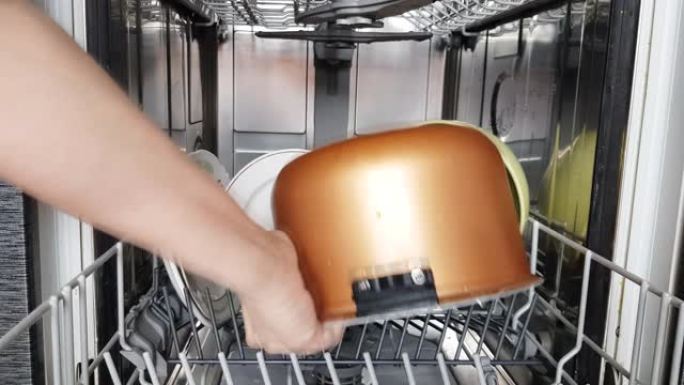 家庭主妇使用现代洗碗机，将干净的碗碟从洗碗机中取出，特写镜头。家用现代家用电器。4k视频。