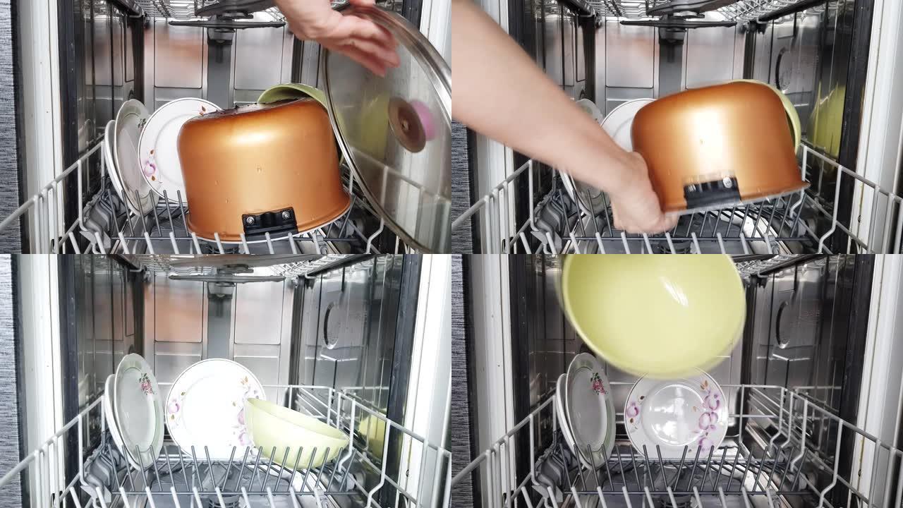 家庭主妇使用现代洗碗机，将干净的碗碟从洗碗机中取出，特写镜头。家用现代家用电器。4k视频。