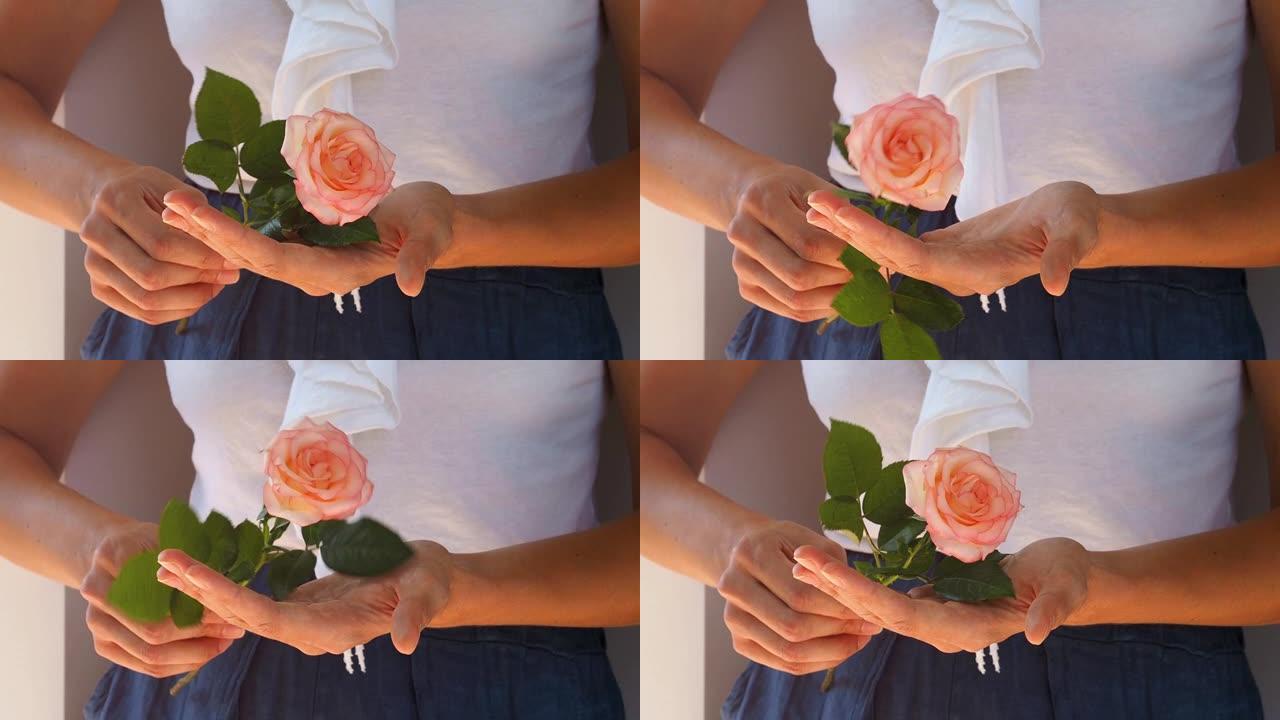 女人手里拿着玫瑰，转动它
