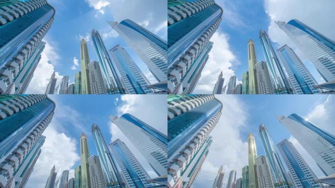 云的时间流逝。办公楼窗户的模式。迪拜市中心城市反射玻璃建筑立面设计。蓝天金融区的城市。