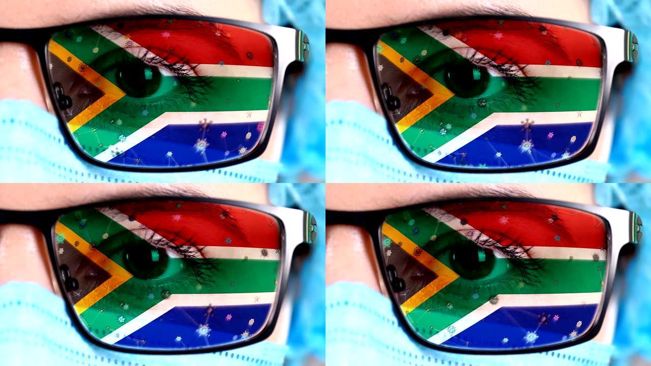 医生脸上的眼镜涂有南非共和国国旗的颜色。许多病毒，细菌在玻璃上移动。国家对疫苗，药物发明，致病病毒研