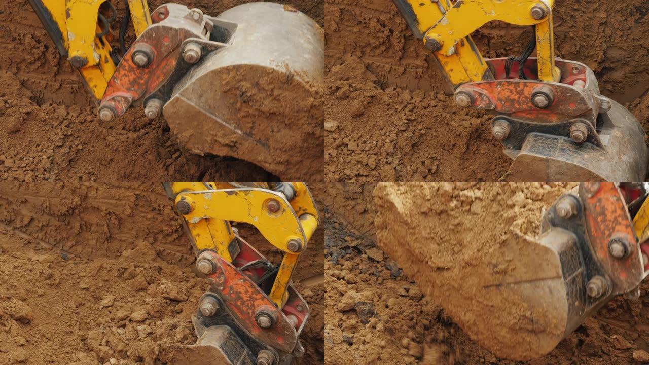 建筑工地的土方设备。挖掘机铲斗从沟渠中清除地面