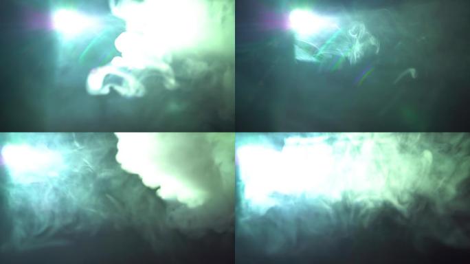 现代视频投影仪和深色背景上的彩色烟雾。烟雾在投影仪的光线中扩散