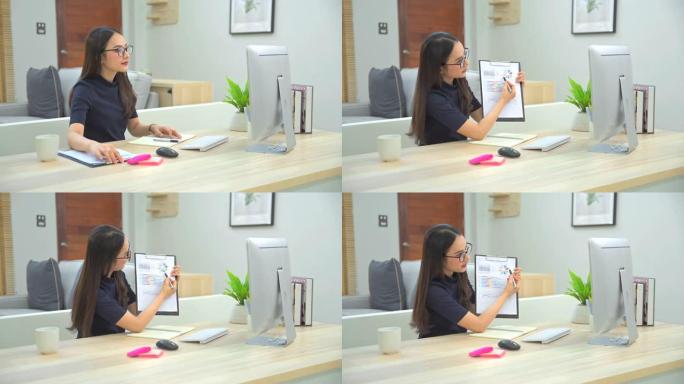 亚洲女商人在视频会议上与同事谈论计划。多民族业务团队使用计算机进行视频通话中的在线会议。一群人在家聪