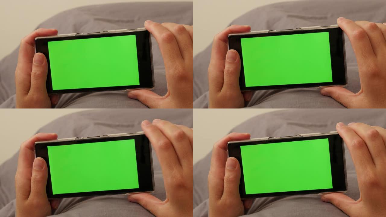 绿屏智能手机4K上换指的女人