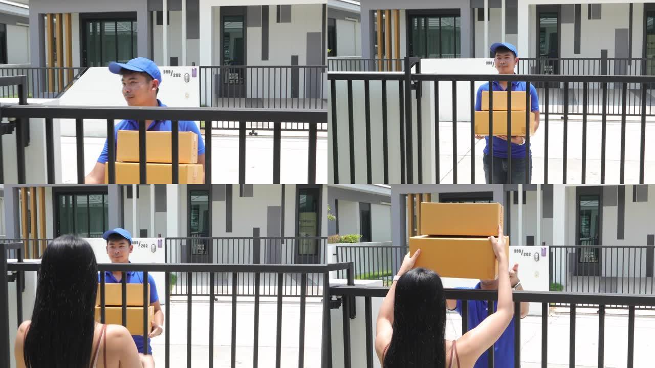 亚洲送货服务人员穿着蓝色制服，戴着蓝色帽子和面罩，处理纸板箱，送给屋前的女顾客。网购快递