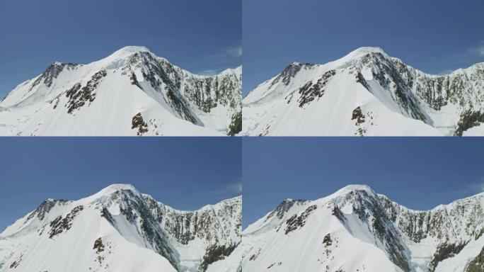 空中全景，雪山顶，充满白雪的山坡，蓝天