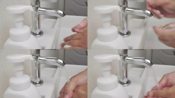 一名男子的手使用消毒剂肥皂泡沫清洁手卫生预防电晕病毒爆发。男人使用一瓶抗菌消毒剂肥皂。
