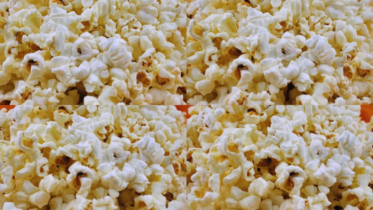 爆米花旋转特写，通风爆米花小吃在电影院，娱乐场所。爆米花背景。爆米花旋转缓慢。