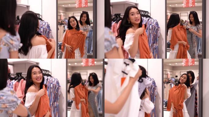 亚洲华裔女性在服装零售店购物和浏览