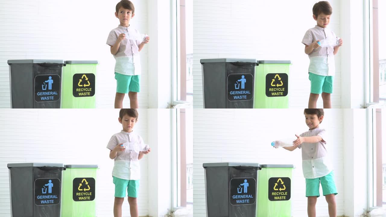 高加索可爱的十几岁的男孩学习分离回收废物，如透明塑料瓶和什么是可回收垃圾箱的象征。家庭生活中儿童的概