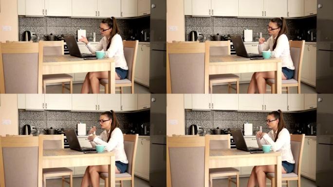 年轻女子通过互联网进行商务对话。在厨房的背景下。不离家就能工作