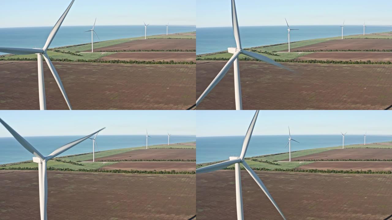 风力涡轮机的特写镜头。空中俯视图风力涡轮机，在白色上方移动的风力涡轮机的现代结构是将风的动能转换为电