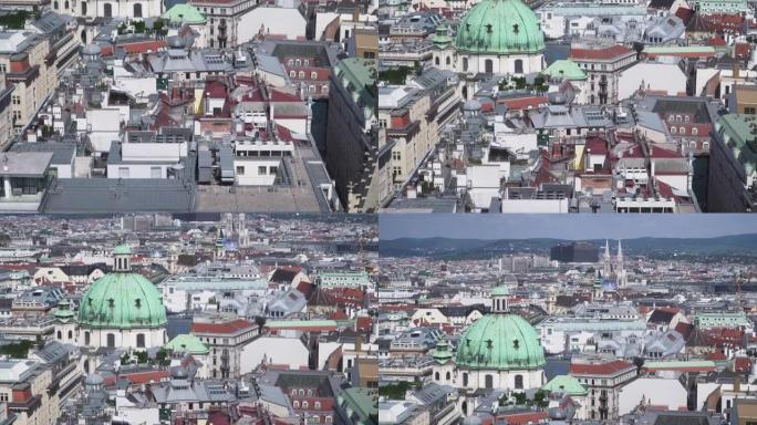 鸟瞰图和倾斜的观点，可以看到建筑屋顶的一部分，哥特式和巴洛克风格，以及首都维也纳的城市景观，在阳光明