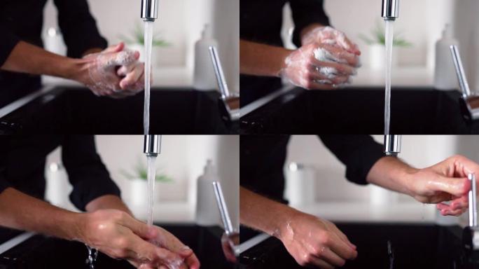 男人在水槽上方用肥皂洗手的侧视图和特写镜头。清洁手指和手掌。水从水龙头倒进厨房的水槽。手部护理和保护