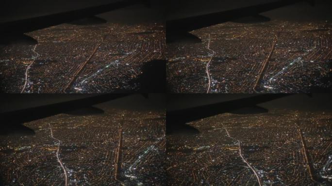 巴西里约热内卢，拉丁美洲的城市景观夜空，房屋和道路被照亮，飞机机翼被拍摄