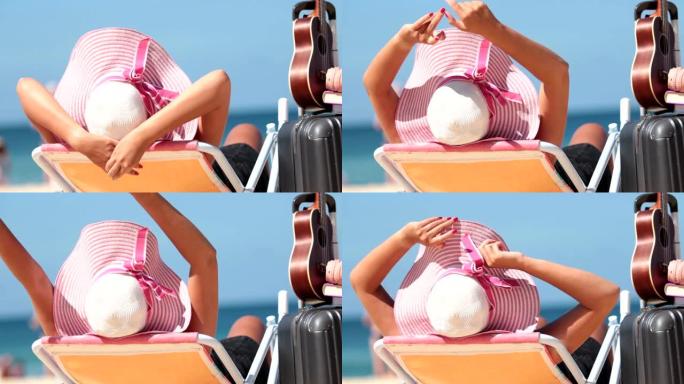 阳光明媚的日子坐在海滩上的女孩的特写镜头。