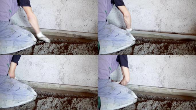 一名建筑工人正在浇筑水泥和混凝土。工头在道路上新浇筑混凝土