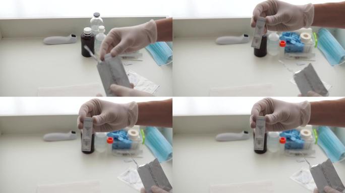 医生戴着手套打开了冠状病毒新型冠状病毒肺炎的快速测试。血液测试准备