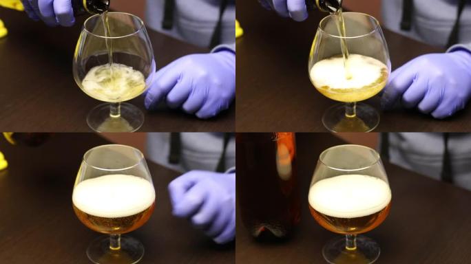 一个戴着手套的年轻人摩擦将啤酒从瓶子倒入玻璃杯中。自我隔离中的休闲。特写镜头。