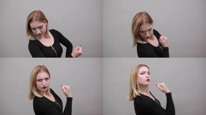 穿黑色夹克的女孩时尚女人展示手臂肌肉象征力量