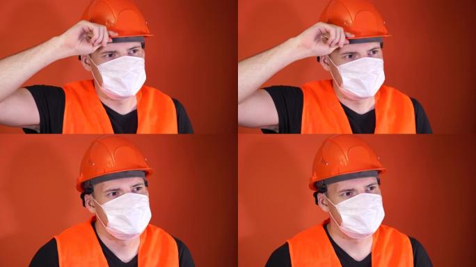 橙色背景上戴着医用面具的年轻人的肖像。成年男性用口罩遮住脸，保护自己免受疾病侵害。冠状病毒流行病或疾