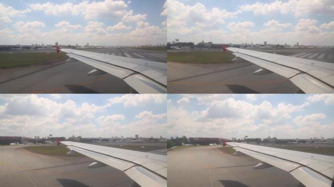 飞机在跑道上滑行，准备从窗户拍摄的机场背景中的蓝天和云彩起飞
