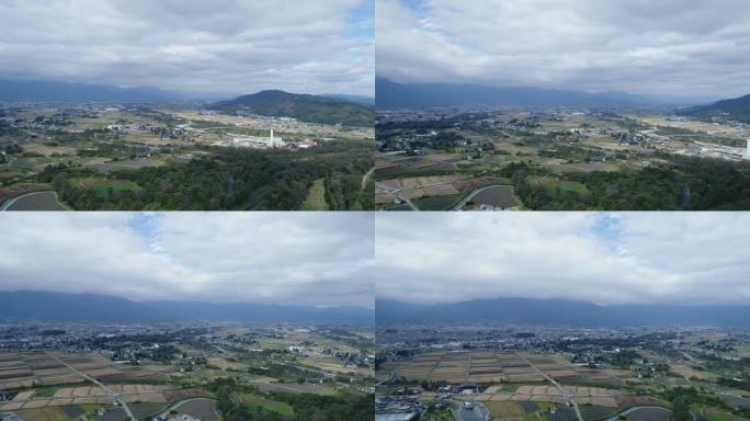 无人机在大奥芥末农场上方拍摄，展示了山脉。长野安津野日本