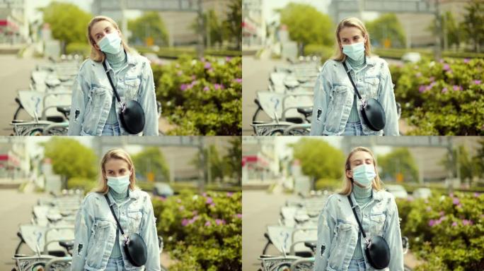 城市中戴着抗菌面具的年轻女子的肖像。