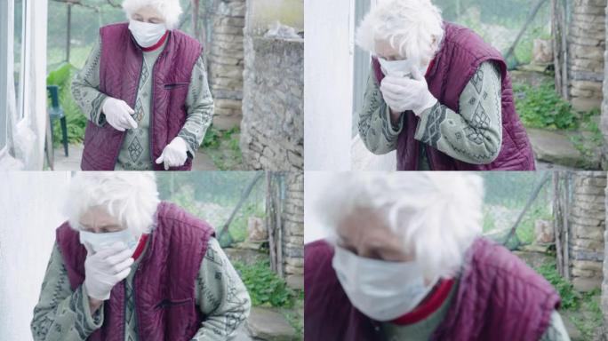 新型冠状病毒肺炎症状。高级妇女在花园里散步时咳嗽。她戴着防护口罩和手套，以避免传染病污染。冠状病毒保