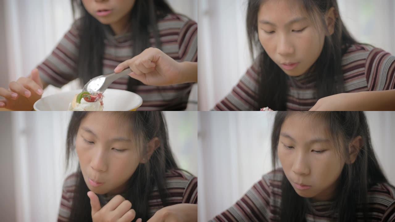 亚洲女孩吃水果蛋糕，酸甜的味道，慢动作。