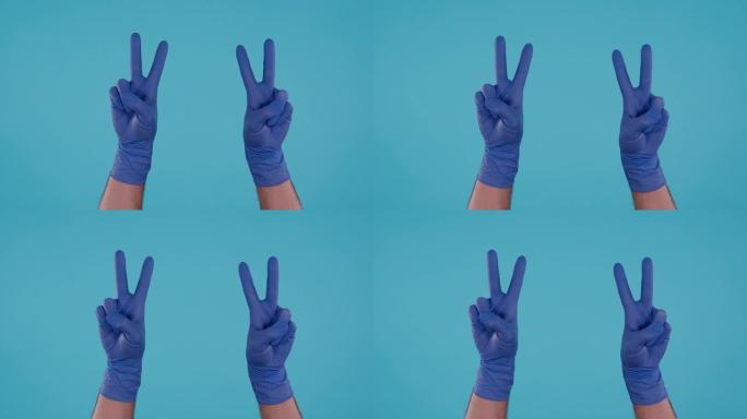 蓝色背景上显示和平标志的蓝色手术乳胶手套的男性手