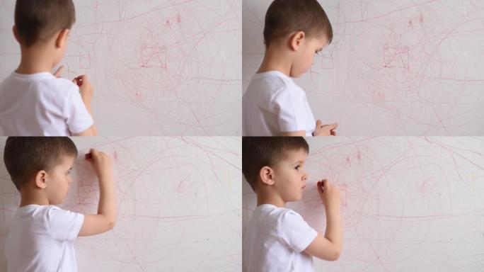 男孩用彩色粉笔在墙上画画。孩子在家从事创造力