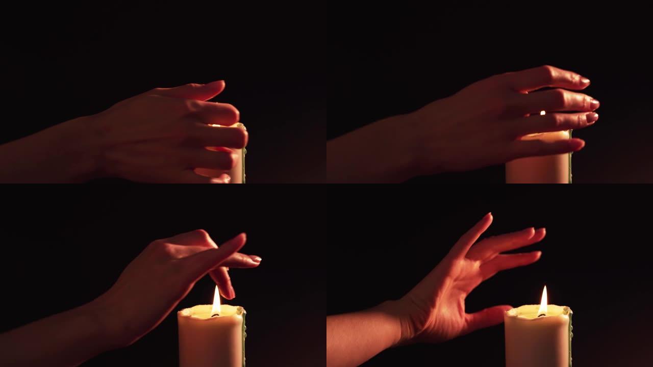 Esoterics和magic-女性的手在黑色背景上点燃的蜡烛上变幻。假面活动和欺骗4k的千里眼