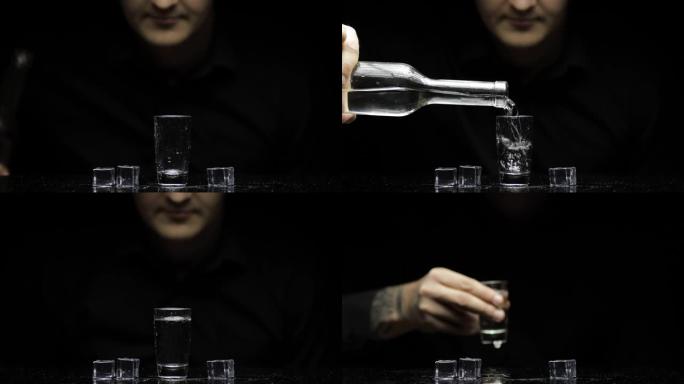 酒保将冷冻伏特加从瓶子里倒入加冰的玻璃杯中。黑色背景