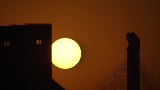 黄昏时，太阳落下，日落天空和剪影建筑背景的延时镜头，远摄镜头4k视频，b卷镜头。