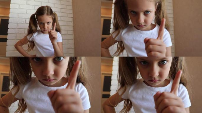 女孩生气地威胁着手指。小女孩不高兴，摇了摇手指。