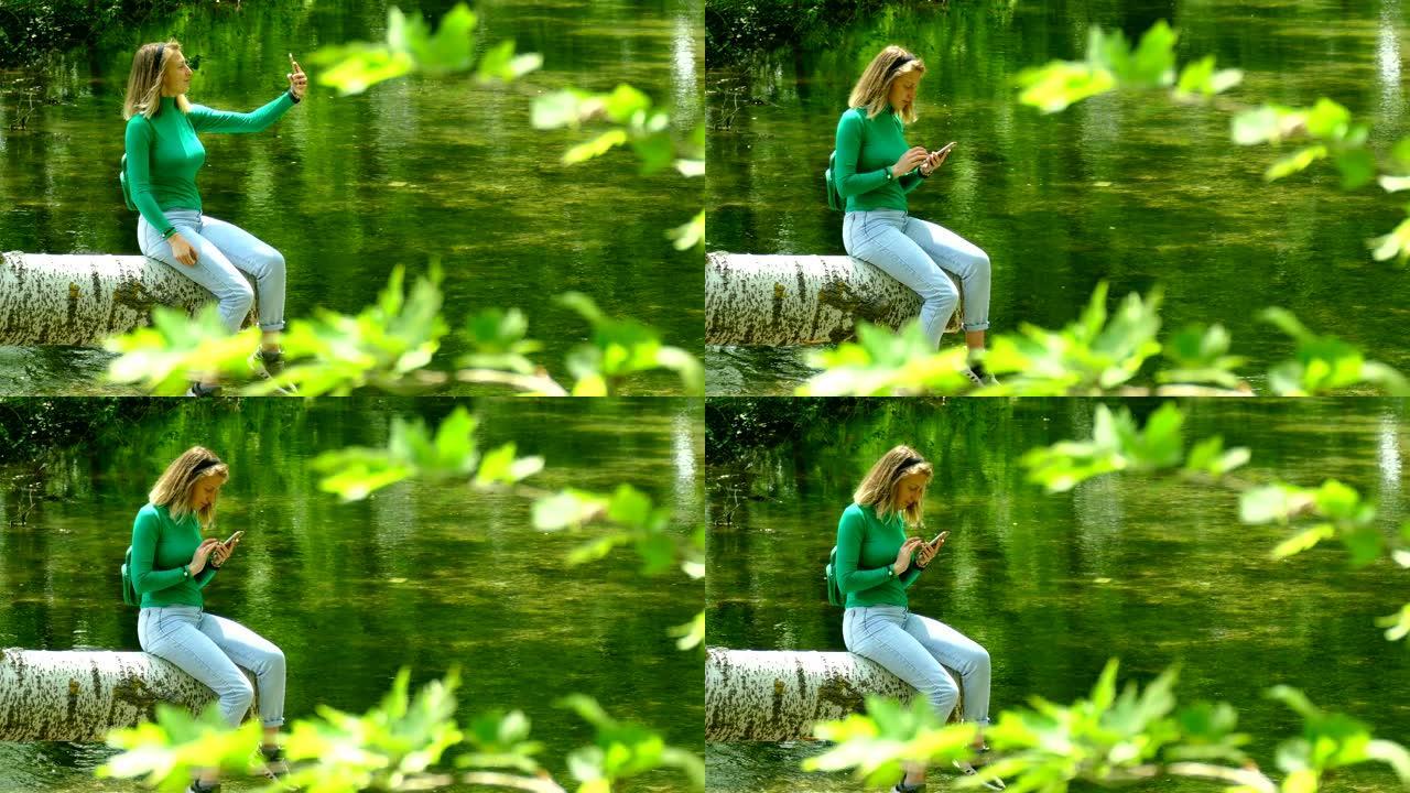 年轻女子在森林灌木丛中的河上被拍照