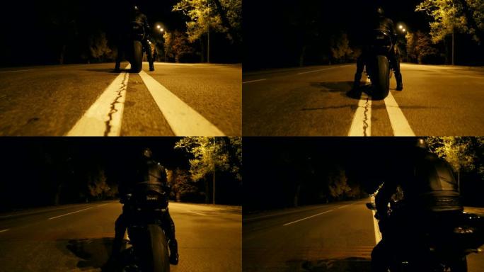 戴着头盔和皮夹克的骑自行车的人在夜间高速公路上坐在摩托车上，准备骑车。男人打算在晚上骑摩托车。自由和