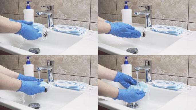 女性用肥皂洗手一次性医用口罩的特写。流行或大流行期间个人护理产品的不足。