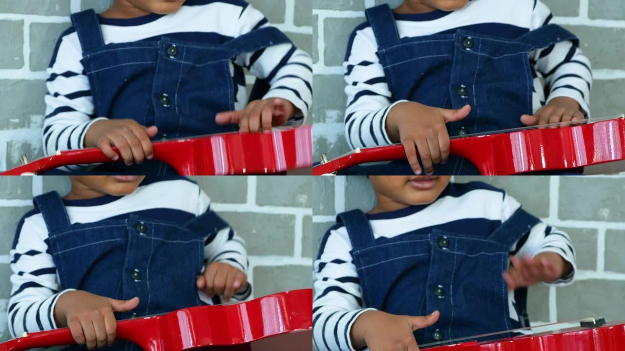 非裔美国人玩吉他玩具的小男孩