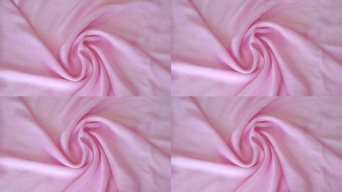 粉色浅色织物的特写镜头。纯棉亚麻。纺织抽象背景。服装行业概念。