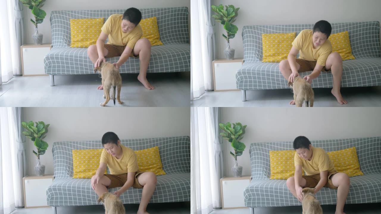 亚洲青春期男孩在家抱着狗，生活方式概念。