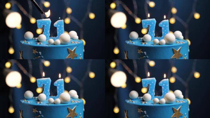 生日蛋糕编号71星星天空和月亮概念，蓝色蜡烛被打火机点燃，然后吹灭。如果需要，请在屏幕右侧复制空间。