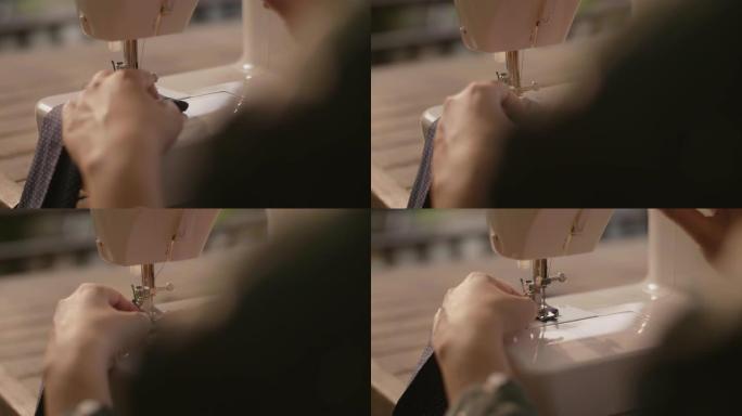 在缝纫机上工作的年轻女性。