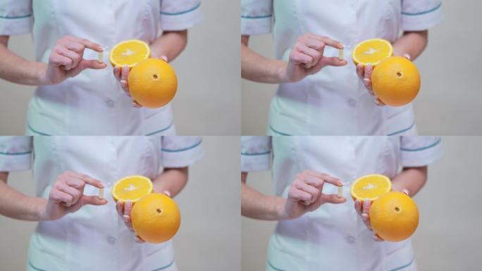 营养师医生健康生活理念-持有维生素药丸和橙色水果